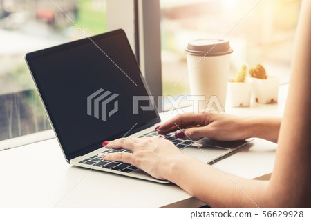 Business woman using laptop computer at cafe. Business woman using laptop computer at cafe. 56629928