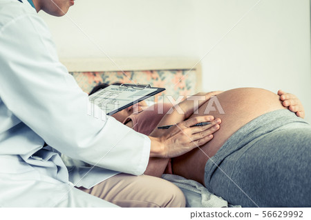 Pregnant Woman and Gynecologist Doctor at Hospital Pregnant Woman and Gynecologist Doctor at Hospital 56629992
