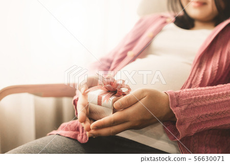 Happy pregnant woman and expecting baby at home. Happy pregnant woman and expecting baby at home. 56630071
