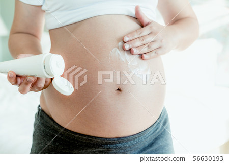 Happy pregnant woman and expecting baby at home. 56630193