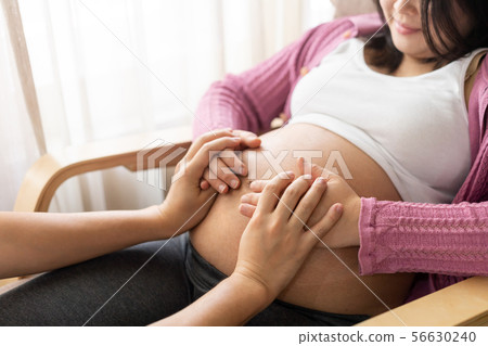 Pregnant couple feels love and relax at home. 56630240