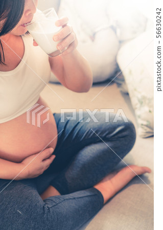 Happy pregnant woman and expecting baby at home. Happy pregnant woman and expecting baby at home. 56630242