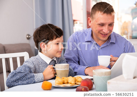Happy boy with father using laptop 56630251