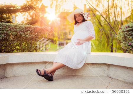 Pregnant woman feeling happy at garden home. Pregnant woman feeling happy at garden home. 56630391