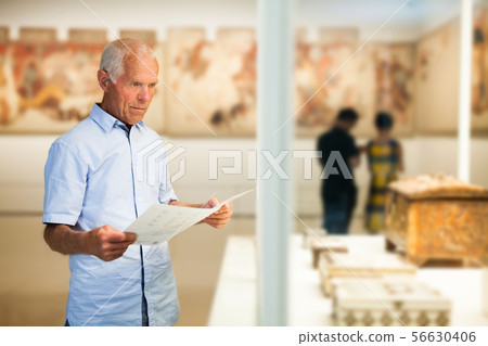 Man exploring artworks in museum Man exploring artworks in museum 56630406