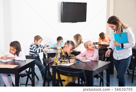 children with teacher in classroom 56630795