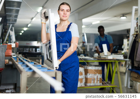 Young woman master is looking on modern window frame 56631145