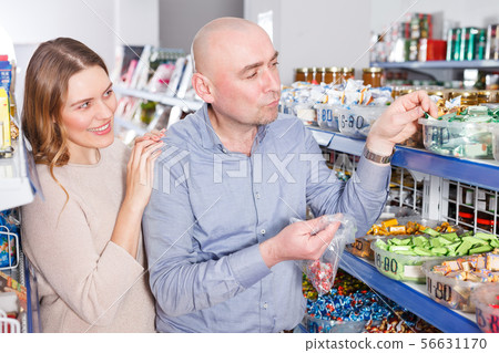 female and male picking candies 56631170