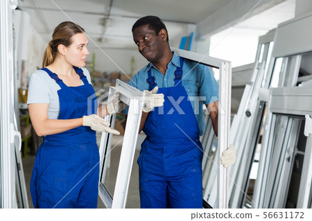 Portrait of man and woman worker who are conflicting with window frames 56631172