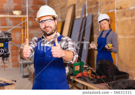 Portrait of successful worker in uniform inside brick cottage 56631331
