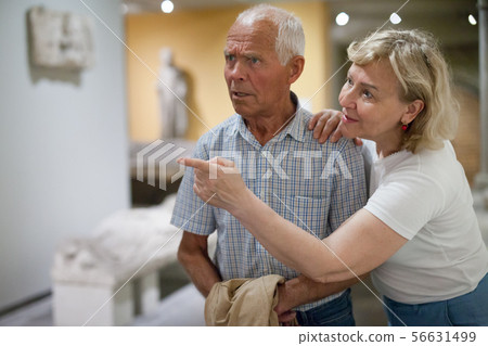 Male and female at exhibition Male and female at exhibition 56631499