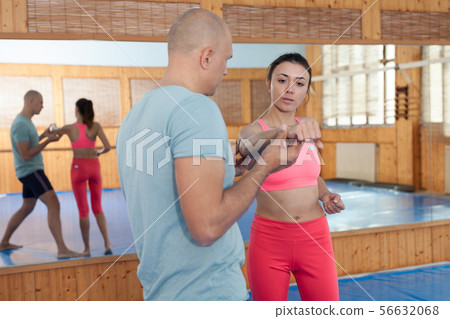 Self-defense workout with personal trainer in gym, martial art 56632068