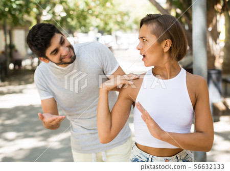 portrait of male and female talking emotional at the street portrait of male and female talking emotional at the street 56632133
