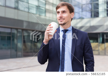 Businessman in suit with cup of coffee Businessman in suit with cup of coffee 56632185