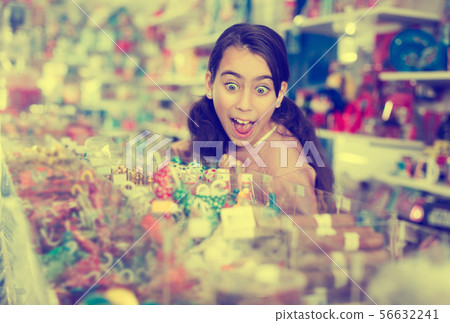 girl with open mouth buying sweet candies girl with open mouth buying sweet candies 56632241