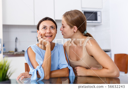 Women friends whispering emotionally 56632243