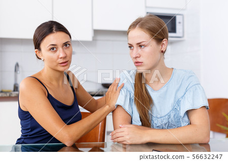 Girl supporting her upset friend 56632247