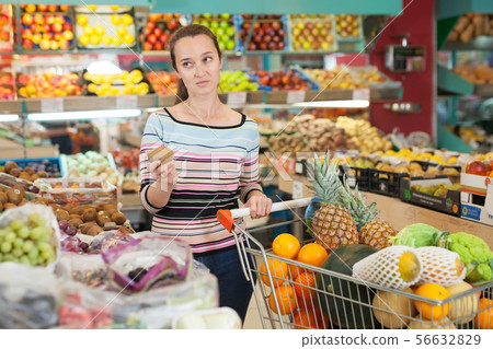 woman shopper choosing fruits woman shopper choosing fruits 56632829