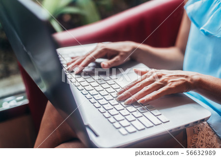 Close-up shot of female hands typing on laptop keyboard 56632989