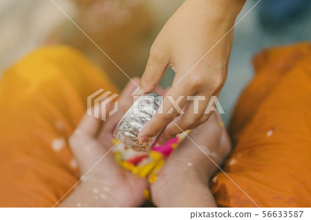 People pouring water to Buddhist Monk  56633587