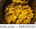 cooked steamed orange quinoa grits in a pan close up 56635910