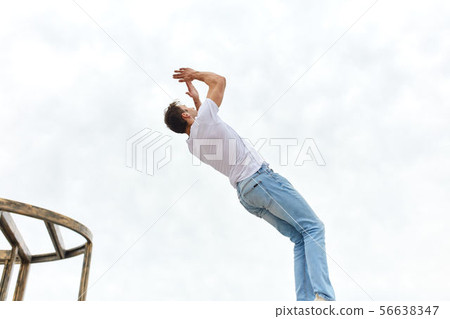 young ambitious man practicing parkour young ambitious man practicing parkour 56638347