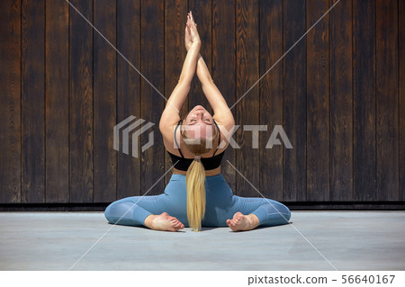Beautiful athletic young girl gymnast in sportswear, working out, element of gymnastics, doing the Beautiful athletic young girl gymnast in sportswear, working out, element of gymnastics, doing the 56640167