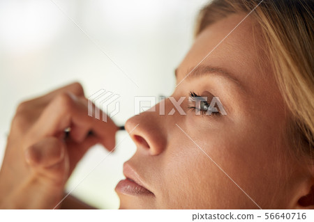 Closeup Of Beautiful Young Woman Face With Beauty Makeup, Fresh Soft Skin And Long Black Thick Closeup Of Beautiful Young Woman Face With Beauty Makeup, Fresh Soft Skin And Long Black Thick 56640716