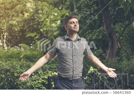 Man feeling relax while enjoy freedom in the park. Man feeling relax while enjoy freedom in the park. 56641360