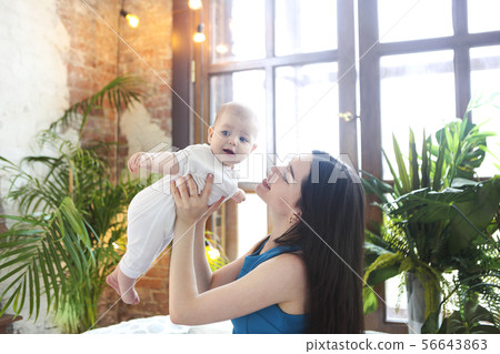 Portrait of mother with her adorable baby boy 56643863