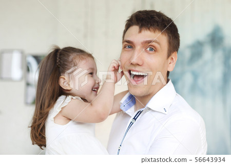 Adorable little daughter embracing father 56643934