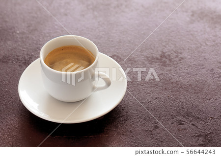 Hot cup of espresso coffee on a table Hot cup of espresso coffee on a table 56644243