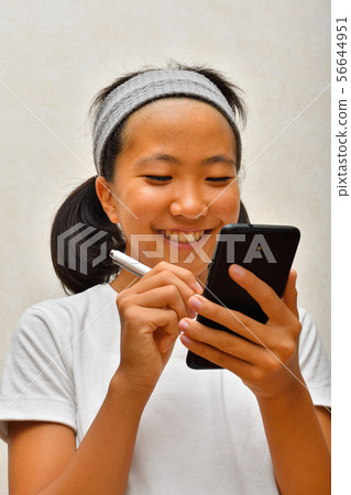 A girl who operates a smartphone (touch pen) A girl who operates a smartphone (touch pen) 56644951
