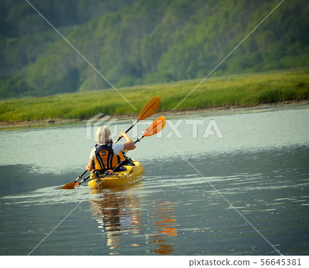 The woman with a child on the lake and ride on 56645381