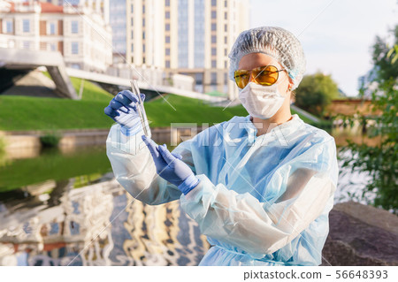 female ecologist or epidemiologist checks water female ecologist or epidemiologist checks water 56648393