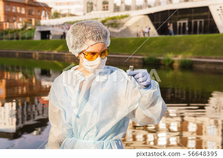 female ecologist or epidemiologist checks water female ecologist or epidemiologist checks water 56648395