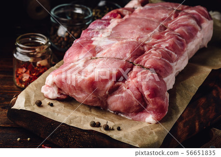 Raw pork loin joint on cutting board 56651835
