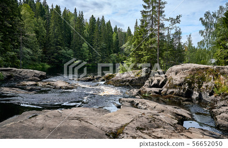 River flows over rocks through the woods. Nothern River flows over rocks through the woods. Nothern 56652050