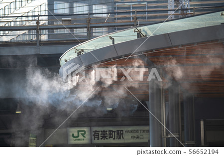 Mist shower installed in front of Yurakucho Station, Tokyo cityscape in Japan 56652194