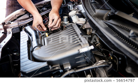 Auto mechanic hand fixing car engine in the garage Auto mechanic hand fixing car engine in the garage 56654797