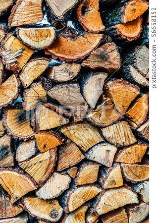 Big wall of stacked wood logs showing natural discoloration Big wall of stacked wood logs showing natural discoloration 56658151