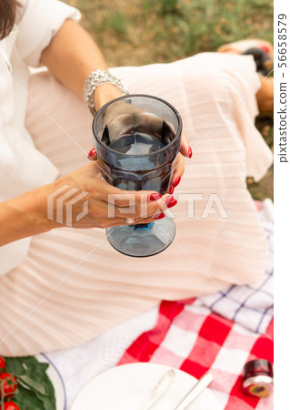 woman drink water from glass at outdoor picnic on 56658579