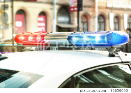 Red and blue signal lights on the roof of a traffic police patrol car 56659000