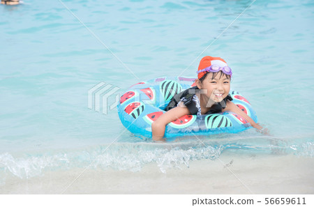 Girls playing in the sea 56659611