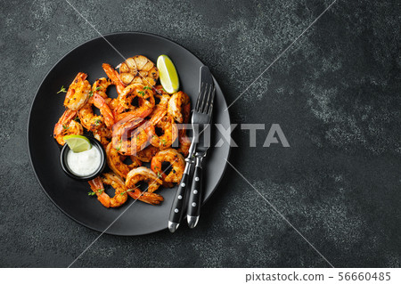 Grilled shrimps or prawns served with lime. 56660485
