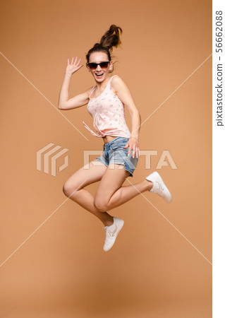 Cheerful brunette young woman in casual outlook Cheerful brunette young woman in casual outlook 56662088