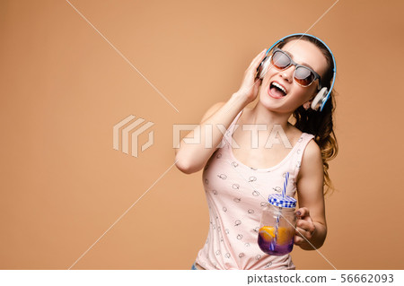 Brunette young lady singing and drinking tasty Brunette young lady singing and drinking tasty 56662093