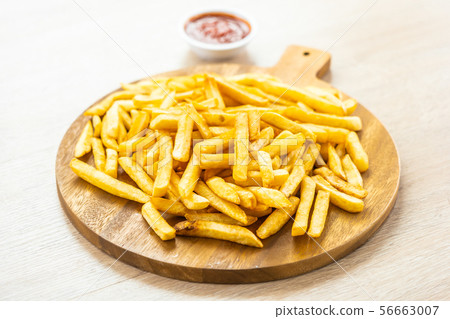 French fries with tomato or ketchup sauce French fries with tomato or ketchup sauce 56663007