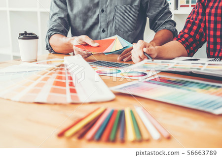 Two Graphic designer Brainstorming Meeting and 56663789