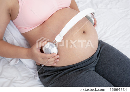 Happy pregnant woman and expecting baby at home. 56664884